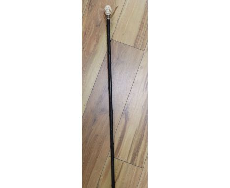 A Victorian ebonised walking cane with ivory skull hand-piece, length 87cm