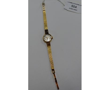 A TISSOT LADIES 9 CARAT GOLD CASED WRIST WATCH ON 9 CARAT GOLD BRACELET - APPROXIMATE WEIGHT = 15.7 GRAMS     