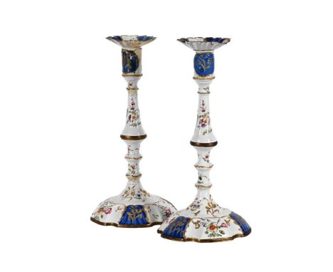A PAIR OF STAFFORDSHIRE ENAMEL CANDLESTICKS  THIRD QUARTER 18TH CENTURY With drip pans Each 27.5cm high Together with a Victo