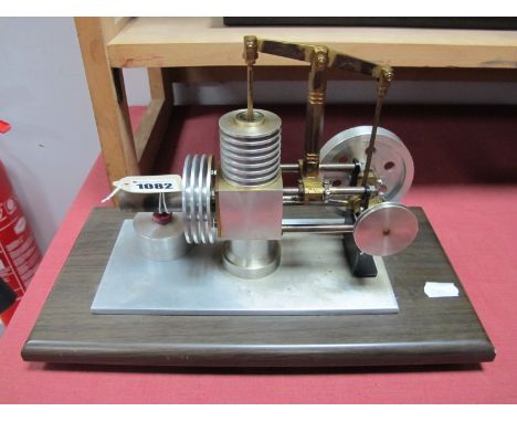 A Stirling Type Hot Air Engine, with  a single cylinder of one inch stroke/half inch bore connected by a overhead beam to a t