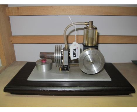 A Well Engineered Stirling Type Hot Air Engine, connected by vertical piston of 1 inch, stroke to a 2.5 inch diameter flywhee