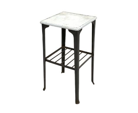 20th century industrial cast and wrought metal lamp table, the square enamel top raised on four supports united by under tier