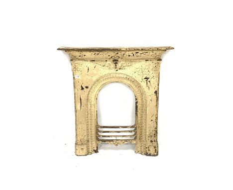 Victorian cast iron fire surround, mantel shelf over scrolled motif leading to a central mask and arched moulded aperture, ap