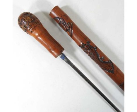 An early 20th century Eastern carved wooden swordstick, 88cm long