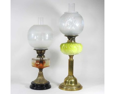 A brass oil lamp with an etched glass shade, together with another with a green glass reservoir, 64cm (2)