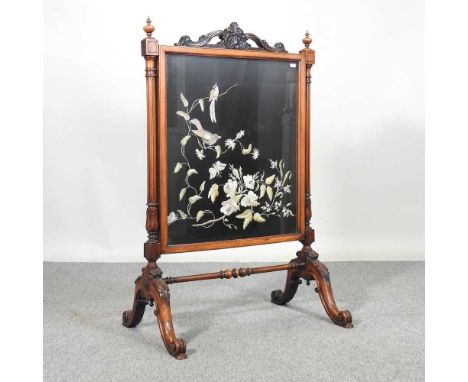 A large Victorian carved walnut fire screen, inset with a tapestry panel of a bird and flowers, on a splayed base68w x 107h c
