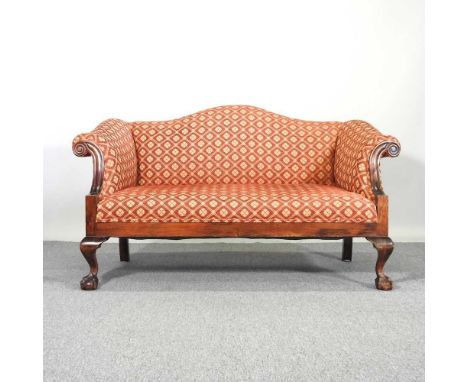 An early 20th century scroll end sofa, of Georgian style, upholstered in red, on cabriole legs, terminating in claw and ball 