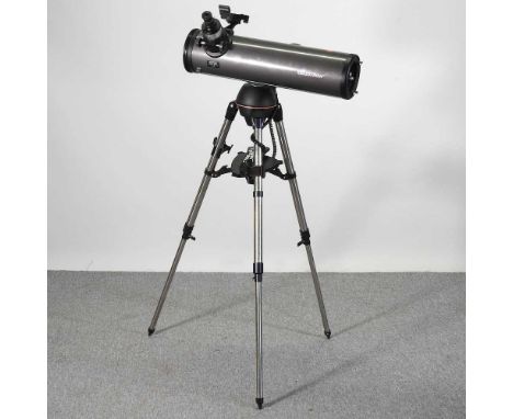 A Celestron NexStar 130SLT stargazing telescope, on a tripod stand, approx 142cm high, with manual, accessories and related b