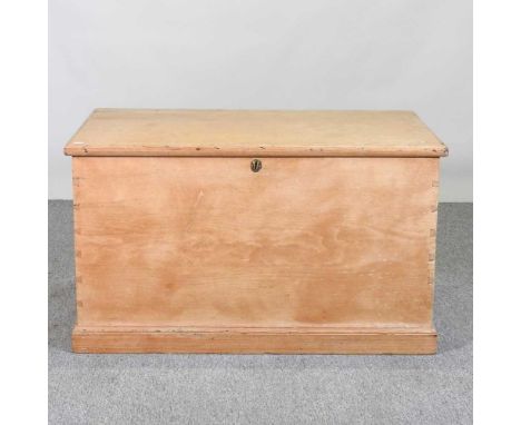 An antique pine trunk, with a hinged lid98w x 58d x 57h cm