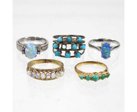 An opal and diamond dress ring, stamped 18K, 3g, size J, together with two turquoise rings and two opal rings (5)