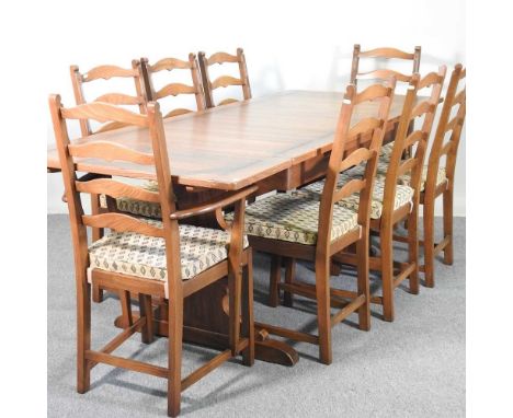 An Ercol extending dining table, together with a set of eight chairs130w x 113d x 75h cm overall