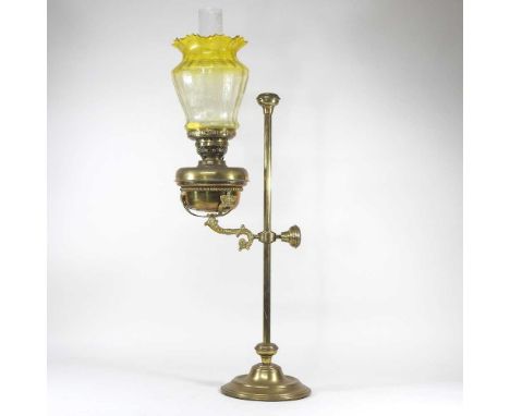 A 19th century brass adjustable oil lamp, with a yellow glass shade, 80cm high