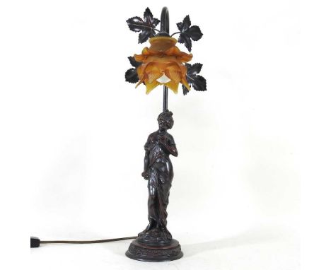 A bronzed figural table lamp, with a frilled amber glass shade, 53cm high