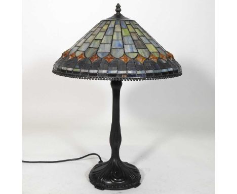 A Tiffany style metal table lamp, with a stained glass shade, 60cm high overall