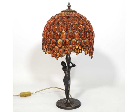 A Tiffany style figural table lamp, with an amber coloured glass shade, 56cm high overall