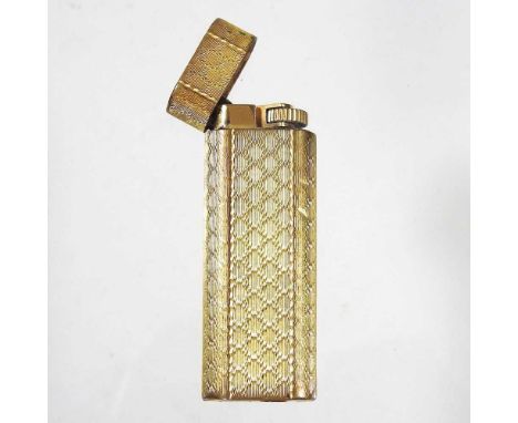 A Cartier gold plated pocket lighter, with engine turned decoration, marked Cartier Paris and numbered E27979, 7cm high