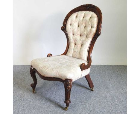 A Victorian cream upholstered show frame button back chair, on cabriole legs