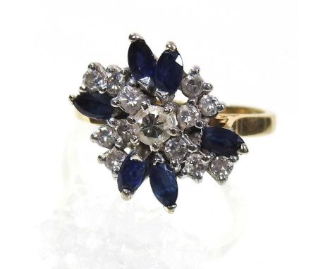 An 18 carat gold sapphire and diamond cluster ring, of asymmetrical design, the central diamond within a diamond and marquise