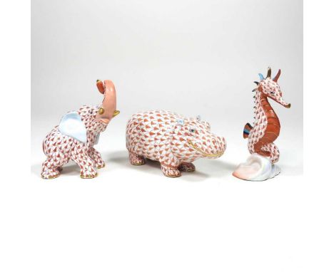 A Herend porcelain model of a seahorse, 10cm high, together with a hippopotamus and an elephant, all in coral fishnet pattern
