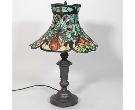 A Tiffany style metal table lamp, with a stained glass shade, 60cm high