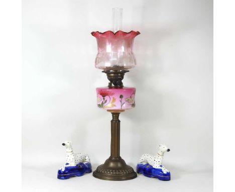 A Victorian oil lamp and shade, 60cm high, together with a pair of Staffordshire style dog inkwells (3)