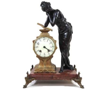 An early 20th century French figural mantel clock, surmounted by a young lady, on a red marble base, 40cm highOverall dirty b