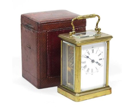 An early 20th century French brass cased carriage clock, 10cm high, in a leather case