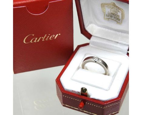 A Cartier 18 carat white gold solitaire diamond ring, approximately 0.21 carats, 4.8g, size G, cased