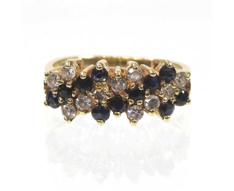 An 18 carat gold sapphire and diamond ring, set with six rows of alternating stones, 4.0g, size L