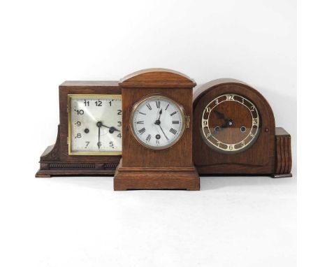 A 1920's oak cased mantel clock, 25cm high, together with two others smaller (3)