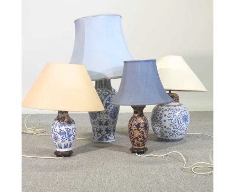 A blue and white pottery table lamp and shade, 80cm high overall, together with three others (4)These are in working order an