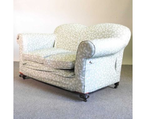 An early 20th century drop end sofa, together with a wing arm chair, both with loose covers (2)151w x 87d x 87h cm