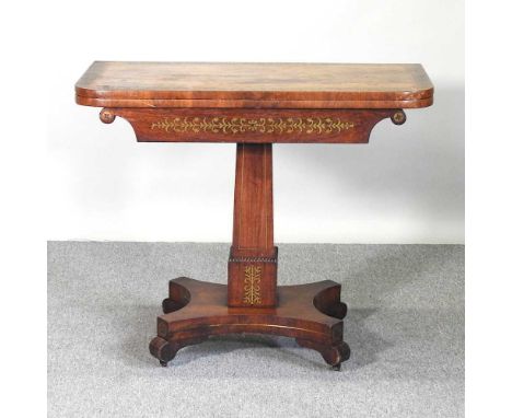 A Regency rosewood and cut brass inlaid folding card table, with a hinged D shaped top, on a square column and platform base9