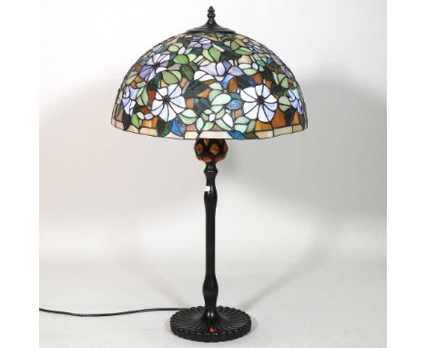 A Tiffany style metal table lamp, with a stained glass shade, 75cm high