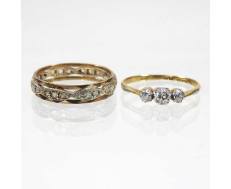 An 18 carat gold three stone diamond ring, 1.4g, size L/M, together with a diamond set full hoop eternity ring 2.2g, size N (