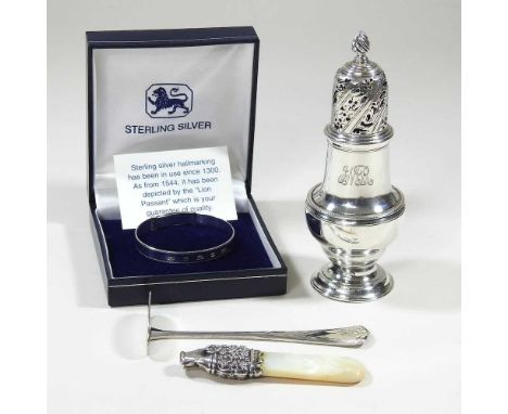 A George III silver caster, of baluster shape, London 1763, 94g, 13cm high, together with silver plated pusher, a mother of p