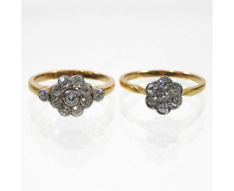 An 18 carat gold and platinum daisy set diamond cluster ring, the central stone, surrounded by eight smaller, with diamond se