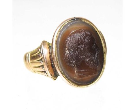 A large carnelian signet ring, carved with a cameo portrait head of a man in profile, unmarked, 2cm, size U, 13.1g grossOvera