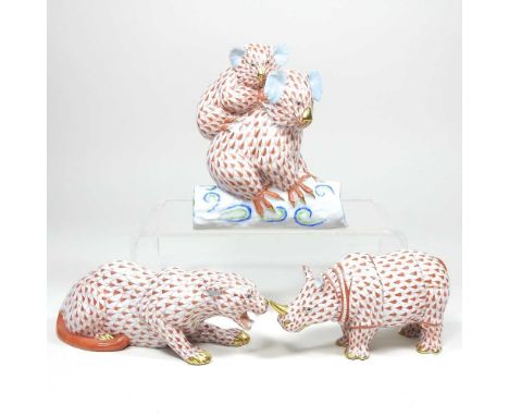 A Herend porcelain model of koalas, 13cm high, together with a rhinoceros and a cheetah, all in coral fishnet pattern (3)All 