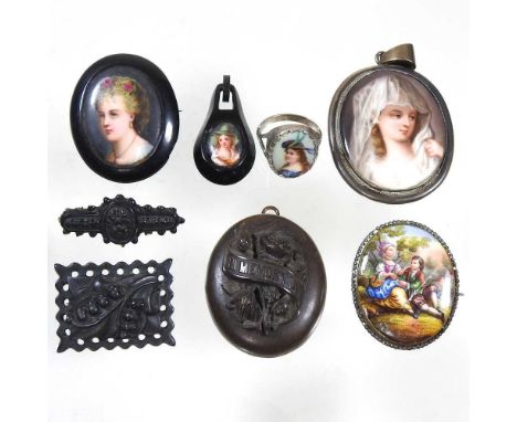 A Victorian jet portrait brooch, painted with the head of a young lady, possibly Whitby, 42 x 38mm, together with three simil