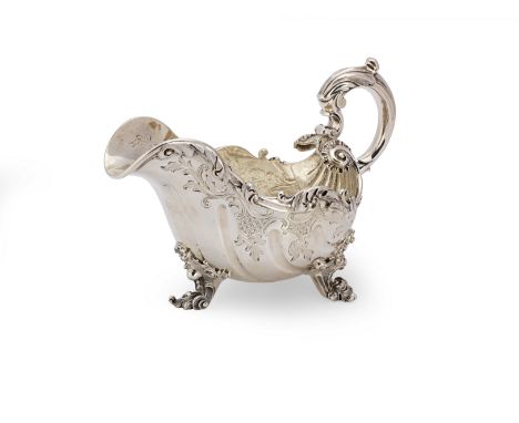 A William IV silver sauce boatPaul Storr, London 1832 Oval form, the body with fluting and foliate chasing, and decorated wit