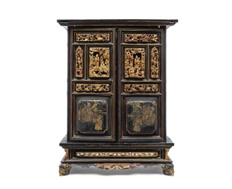 A Chinese gold and black lacquered two-door rectangular cabinetLate Qing dynastyThe front of the doors inset with high relief