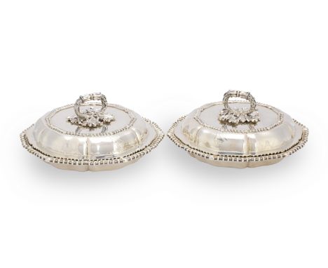 A pair of George IV silver entrée dishesPaul Storr, London 1831 Of lobed circular form with gadroon borders, surmounted by oa