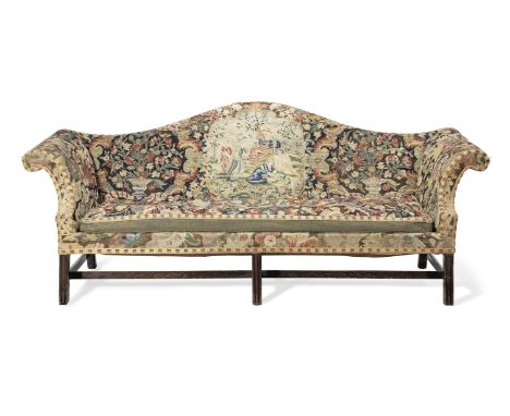 A George III mahogany sofaWith an arched back and scrolled arms, upholstered in 18th century gross and petit point needlework