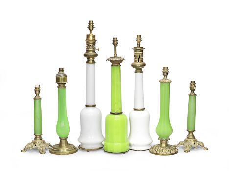 A collection of glass lampsIncluding a pair of green glass stem lamps, with cast brass pierced foliate bases, together with a