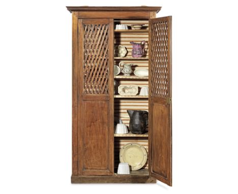 A French 19th century cherry wood kitchen cupboard containing a collection of vintage kitchenaliaThe pierced trellis panelled