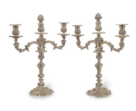 A pair of George III silver three-light candelabraJoseph Cradock and William K. Reid, London 1819 With two scrolling acanthus