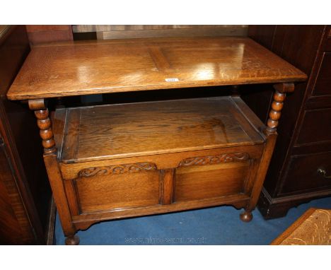 A modern good quality light Oak Monk's Bench, having cleated top/back, arms on bobbin turned supports, cleated end lift-up li