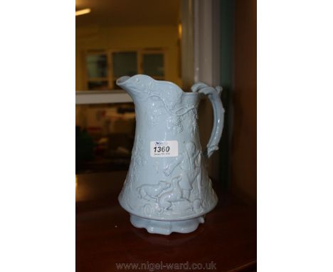A pale blue china Ale Jug with Hunting Scenes, the handle being in the form of a tree branch, 8 3/4" tall.