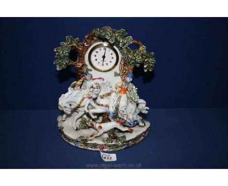 A Mercedes clock face set into a Staffordshire style case with figures on horseback hunting with a eagle and a hound under a 